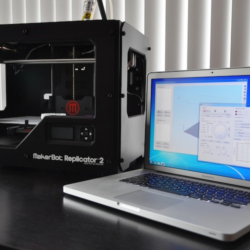 Simplify3d - Makerbot Replicator 2 printer next to laptop